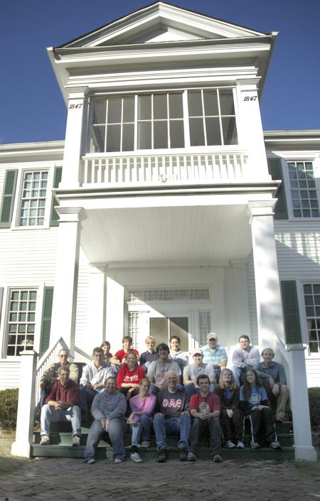A group of history faculty and students pose for a group shot at the Ames Plantation after a day of grave site searching during a Day of Remembrance project. - Photo by Matthew Diggs