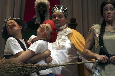 Kali Wagner and Emily Watlington as the pigs Marcellus and Amadeus are in a state of terror as Natalie Newberry, Trevor Yarbrough and Jonathan Lambach watch when the wolf comes knocking at the pigs' door in the production of <em>The Trial of the Big Bad Wolf</em>. - Photo by Kyle Kurlick