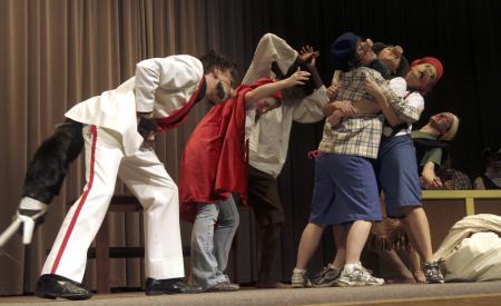The wolf, played by Andy Morris, attempts to blow down the house of bricks in the Union University Players production <em>The Trial of the Big Bad Wolf</em>. - Photo by Kyle Kurlick