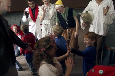 While the audience exits the chapel, the cast of <em>The Trial of the Big Bad Wolf</em> man the exits and thank the children for attending and line up to high five the kids on their way out. - Photo by Kyle Kurlick