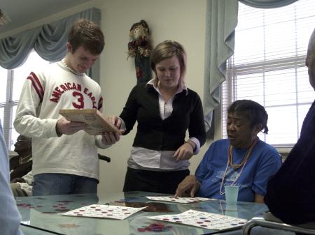 When Ethel Jones called bingo, GO Thailand teammates Matt Taylor and Amy Brown came to check her board at Mission Convalescent Home during Day of Remembrance.  - Photo by Beth Spain