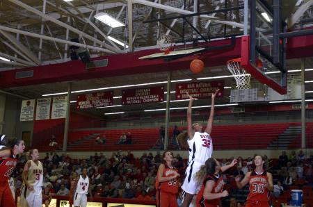 Natanya Smith jumps high for a rebound against Georgetown College, Ky. - Photo by Stephanie Schroeder