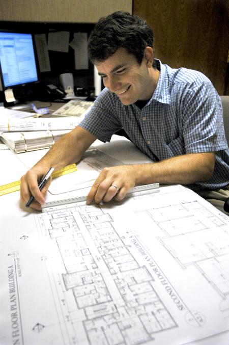 Mark Maddox, architectural draftsman for TLM Associates, Inc., works on most of the general draft for White Hall, the new science building.  - Photo by Matthew Diggs