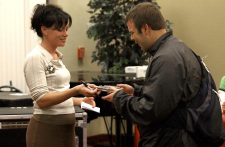 Christian recording artist Sara Groves autographs her CD for junior Tyler Glodjo, Christian studies major, after the 2006 Homecoming Coffee House.  - Photo by Matthew Diggs
