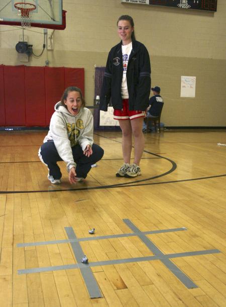 Lauren Norton watches as Jenny Emanuel plays a tic-tac-toe game at the carnival during Frost Fest put on by SAC. - Photo by Stephanie Schroeder