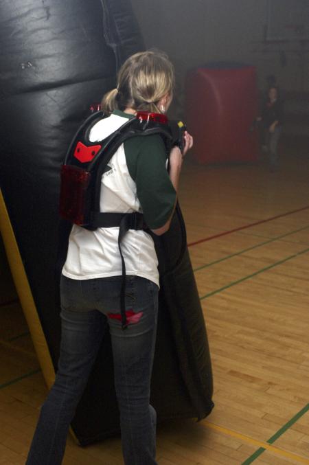 Kasey Cobb stands guard and prepared to shoot her laser gun to gain points in a laser tag game held in the small gym during Frost Fest put on by SAC. - Photo by Stephanie Schroeder