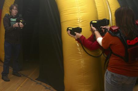 Bryan Emerson, Hunner Coward and April McCulley shoot each other to gain points in a laser tag game held in the small gym during Frost Fest put on by SAC. - Photo by Stephanie Schroeder