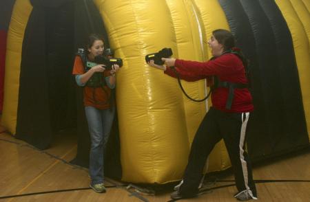 Rachel Daniel and Hunner Coward shoot each other in a laser tag game held in the small gym during Frost Fest put on by SAC. - Photo by Stephanie Schroeder