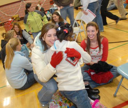 Rachael Moore gives her child a big hug during the SAC Carl Perkins' Christmas Party. - Photo by Morris Abernathy