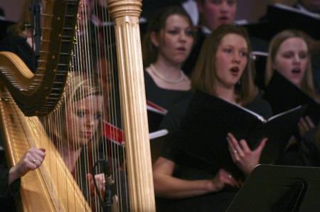 Katie McCoy plays on the harp to accompany Choral Union during A Union Christmas. - Photo by Stephanie Schroeder