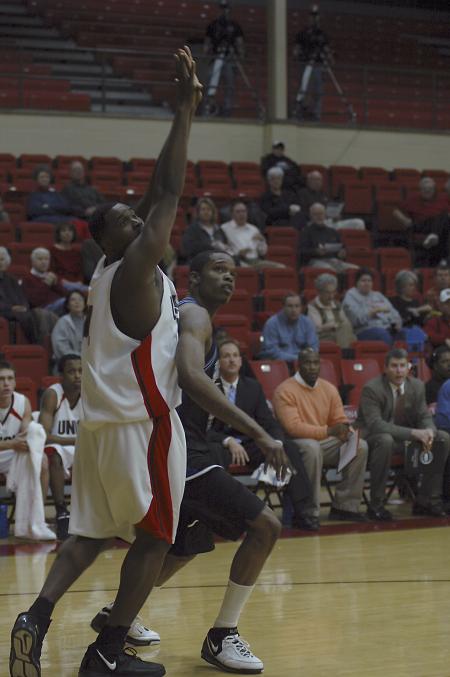 Senior Pierry Valmera uses his height to guard a Mountain State University player. - Photo by Holly Gushee