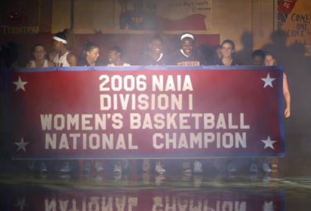The Union University Lady Bulldogs hold their championship banner proudly during a ceremony before the homecoming basketball game.   - Photo by Heather Phillips