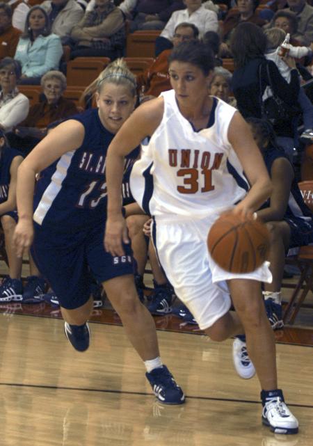 Merideth Richardson (31) tries to get past one of the opposing guards during the homecoming basketball game at Union.      - Photo by Heather Phillips