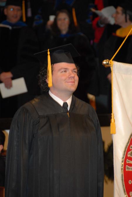 SGA President Josh Clarke watches from the stage as the fall graduates enter West Jackson Baptist Church. - Photo by Morris Abernathy