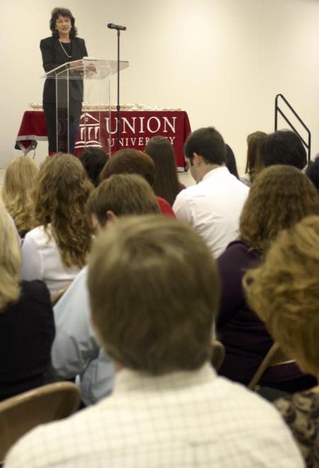 Sandra Hathcox, Union faculty and representative from the Gideon Auxillary, presents Bibles to the nursing graduates during their annual pinning ceremony. - Photo by Stephanie Schroeder