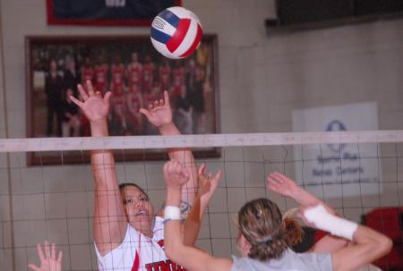 Senior Monica Schirmer goes up for a block. - Photo by Morris Abernathy