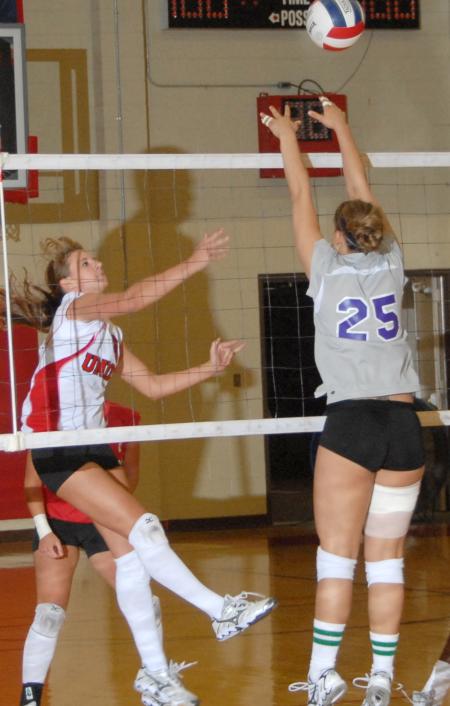 Junior Kelly Huffines attemps to block a shot by the opponents. - Photo by Morris Abernathy