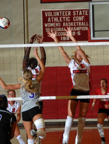 Sophomore Amanda Hutchison attempts to block the ball. - Photo by Morris Abernathy