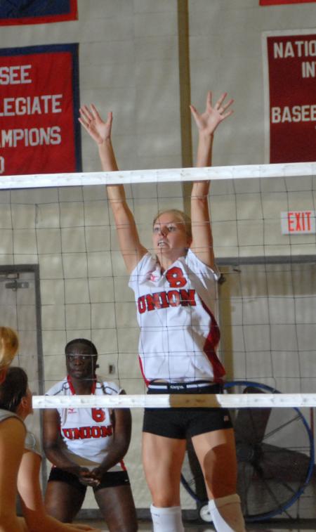 Sophomore Amanda Hutchison attempts to block a shot. - Photo by Morris Abernathy