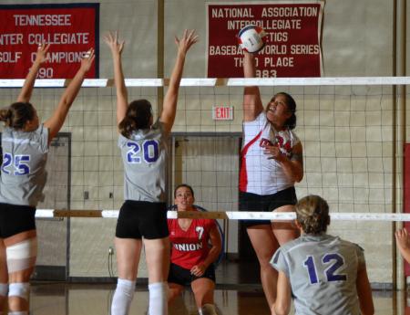 Lady Bulldog senior Monica Schirmer spikes the ball. - Photo by Morris Abernathy