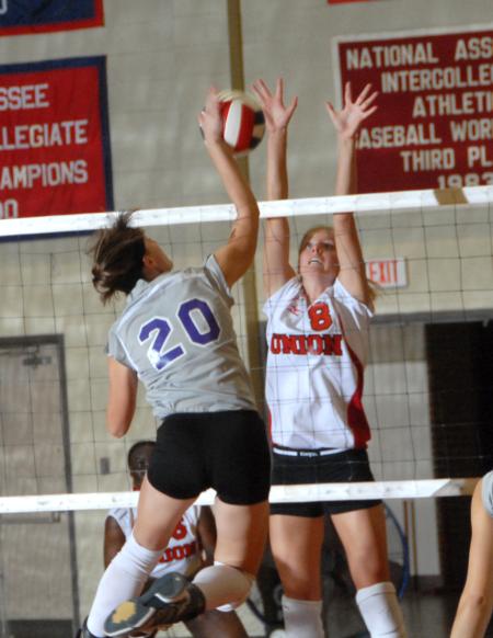 Sophomore Amanda Hutchison blocks a spiked ball. - Photo by Morris Abernathy