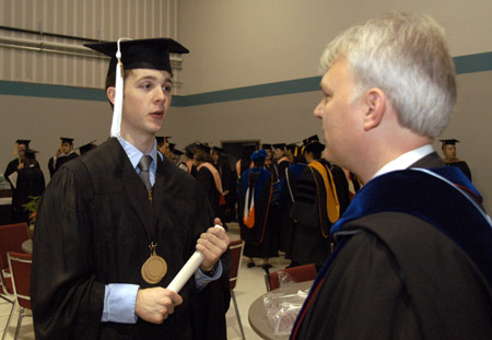 Christian Studies major Will Cherry from Germantown, TN talks with professor Mark Dubis as graduates begin to organize just before Union's December graduation ceremony. - Photo by Jim Veneman
