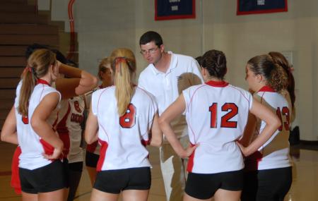 Head coach Steven Gream gives the Lady Bulldogs some instruction between matches. - Photo by Morris Abernathy