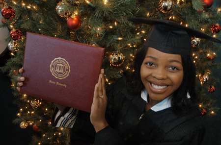 Computer Science major and Career Services secretary Renee Jones shows off her diploma shortly after Union's December graduation ceremony. - Photo by Jim Veneman