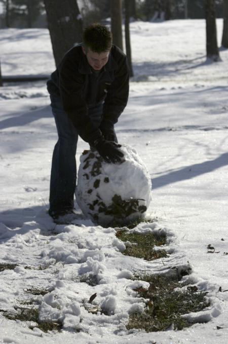 Scott Harden used the little bit of snow that came to campus to build a snow man.  Many students around campus built their own versions of snow men during the school's snow day. - Photo by Stephanie Schroeder