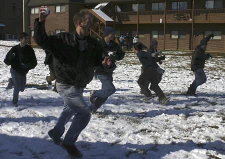 John Henson and other men of McAfee charge each other during a snow ball fight in the McAfee courtyard during a snow day. - Photo by Stephanie Schroeder