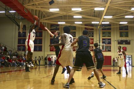 Brian Lake shoots the ball as Deywane Lee helps block opponents from Trevecca Nazarene University. The game ended in a victory for the Union Bulldogs. - Photo by Stephanie Schroeder