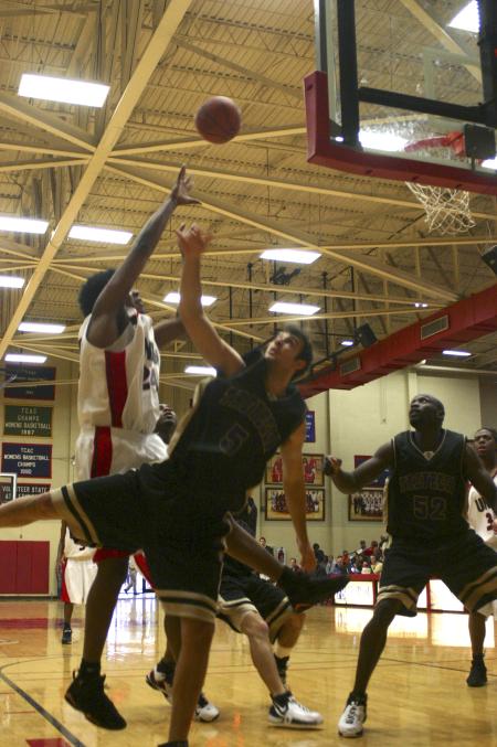 Deywane Lee jumps over Trevecca Nazarene University opponents as he shoots and scores. - Photo by Stephanie Schroeder
