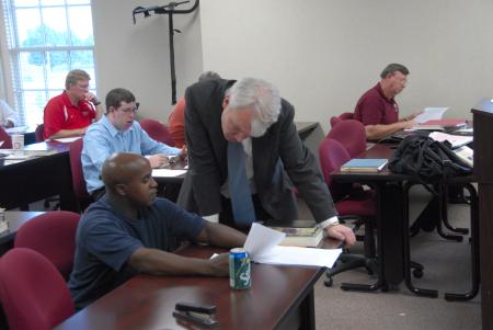 Mark Dubis, associate professor of Christian studies, works with an MCS student during class. - Photo by Morris Abernathy