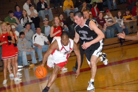 Senior Mack Bealim drives past a Freed-Hardeman defender in Union quarterfinal win in the TranSouth Conference Tournament. - Photo by Morris Abernathy