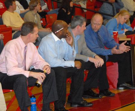 The Bulldog coaching staff strategizes during the quarterfinal matchup in the TranSouth Tournament.  From left to right: Cliff Pawley, trainer; Chima Abakwue, graduate assistant; David Niven, assistant coach; and Ralph Turner, head coach. - Photo by Morris Abernathy