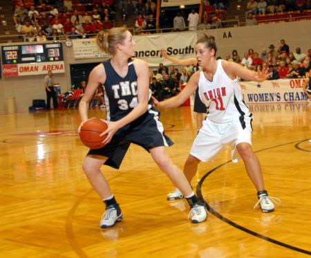 Freshman Kaitlin Dudley guards a Master's College player during the first round of the NAIA National Tournament. - Photo by Morris Abernathy