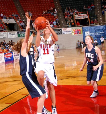 Freshman Kaitlin Dudley fights to make a shot against The Master's College during the first round of the NAIA National Tournament. - Photo by Morris Abernathy
