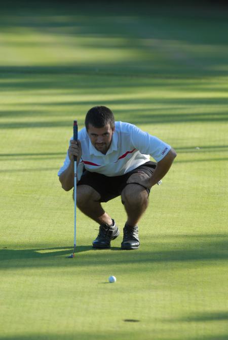 Matt Wood, in the Union Invitational at Falcon Ridge Golf Club, eyes the line of a put. - Photo by Morris Abernathy