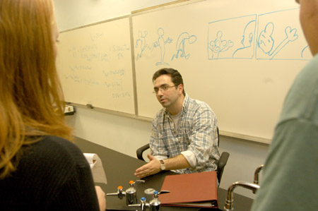 Kirby Atkins speaks with a small group of students after his talk on computer animation and digital filmmaking. - Photo by Jim Veneman
