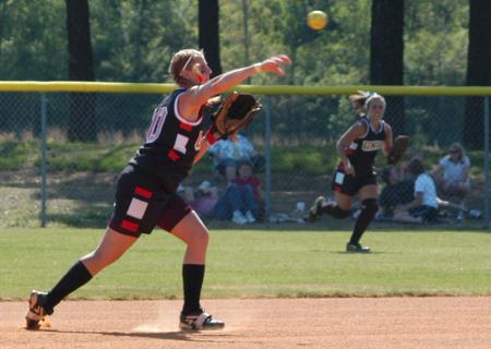 Second baseman Heidi Bybee makes a throw to first for the out as right fielder Candace Cross moves to back up the play. - Photo by Steven Aldridge