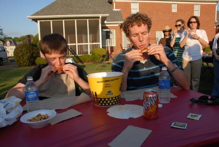 Richard Hart and Douglas Martin battle it out in a wings eating competition during Happy Trails. - Photo by Morris Abernathy