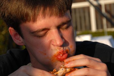 Richard Hart gets messy in a wings eating competition during Happy Trails. - Photo by Morris Abernathy