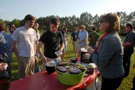 Provost Carla Sanderson offers ice cream to member of the Class of 2007 during a gathering at President Dockery's home. The annual celebration marks the beginning of spring graduation festivities. - Photo by Morris Abernathy