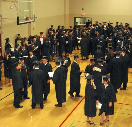 Graduates gathered in the small gym waiting to line up for the processional to the spring 2007 graduation ceremony. - Photo by Beth Spain