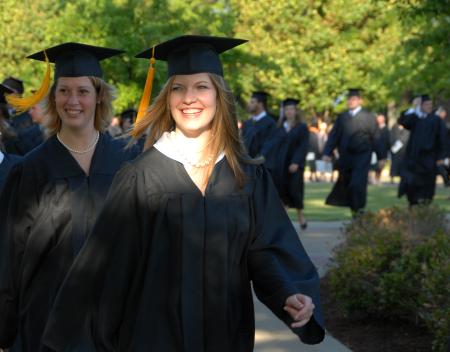Social Work graduates Elisabeth Berry and Leah Booth file onto the Great Lawn for the spring 2007 graduation. - Photo by Morris Abernathy