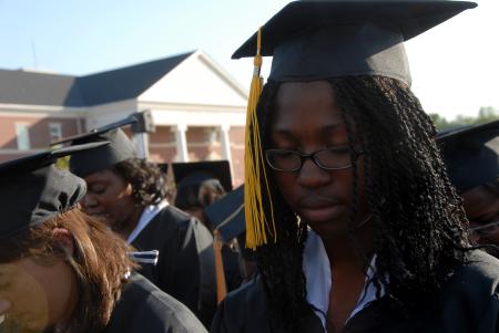 Jande Jackson prays with other members of the class of 2007 during spring graduation on Union's Great Lawn. Jackson is a digital media studies graduate from Franklin, Tenn. - Photo by Morris Abernathy