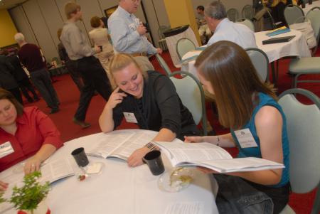 TESL Majors Allysha Martin and Kimberly Walter look over the program at the 2007 Scholarship Symposium. - Photo by Morris Abernathy