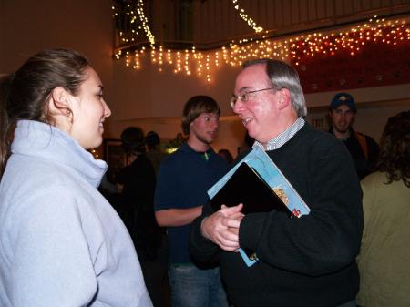 President Dockery speaks to Katie Daniel after reading the Christmas story to students in the McAfee Commons. - Photo by Beth Spain