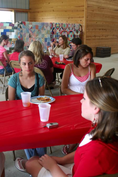Rising Senior Emily Watkins talks with Molly Merck (bottom) during a cookout held at the home of Professors Keith and Beverly Absher. - Photo by Stephanie Schroeder