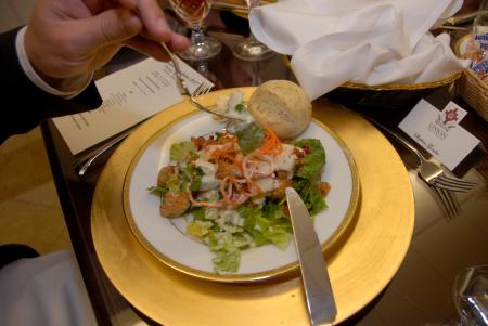 Steven Goodin learns how to properly hold a fork during Career Services' Etiquette Luncheon. - Photo by Morris Abernathy